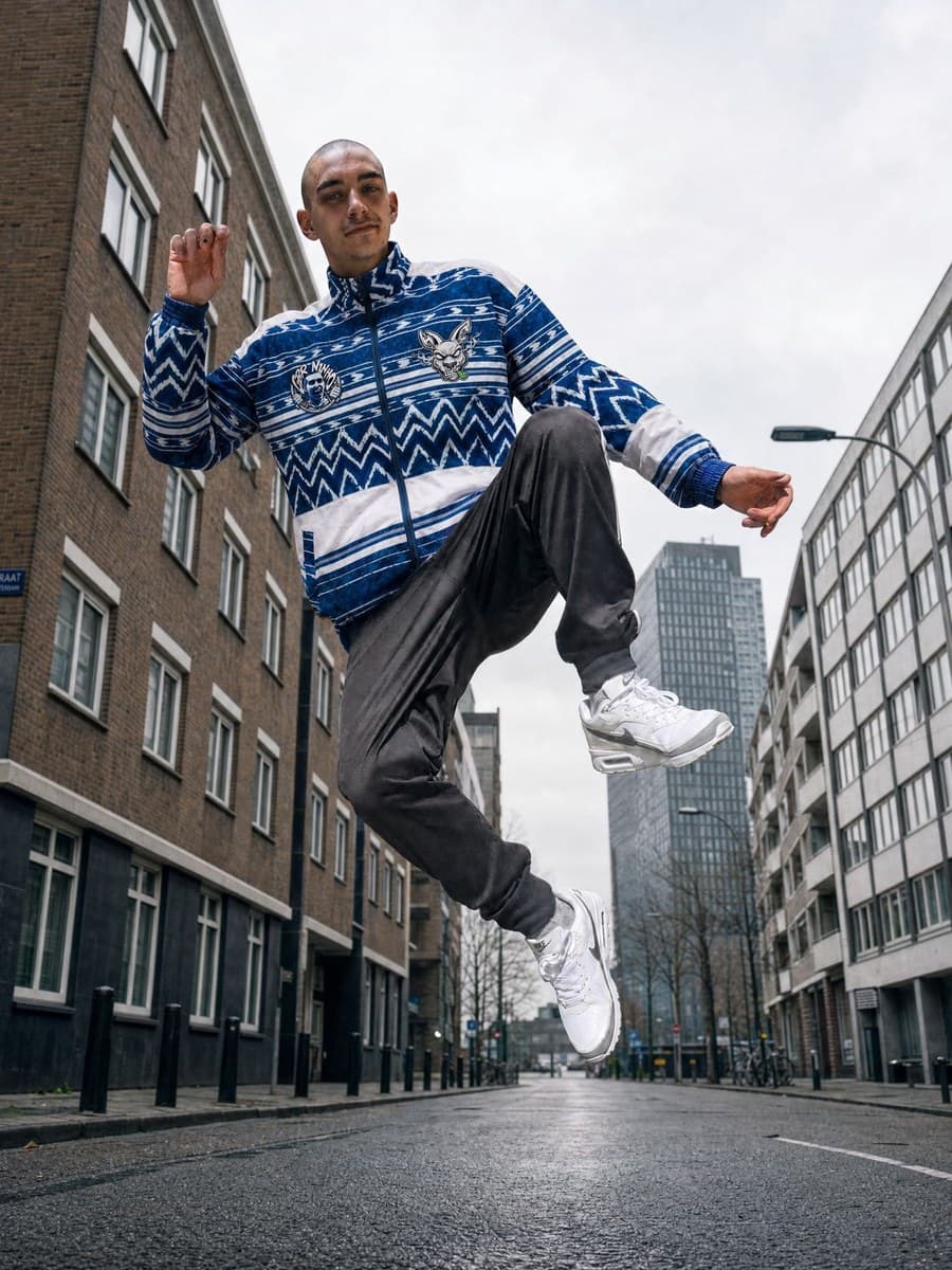 Dancer jumping in a city street, shot from below